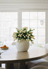 spring fake tulips in white konos vase