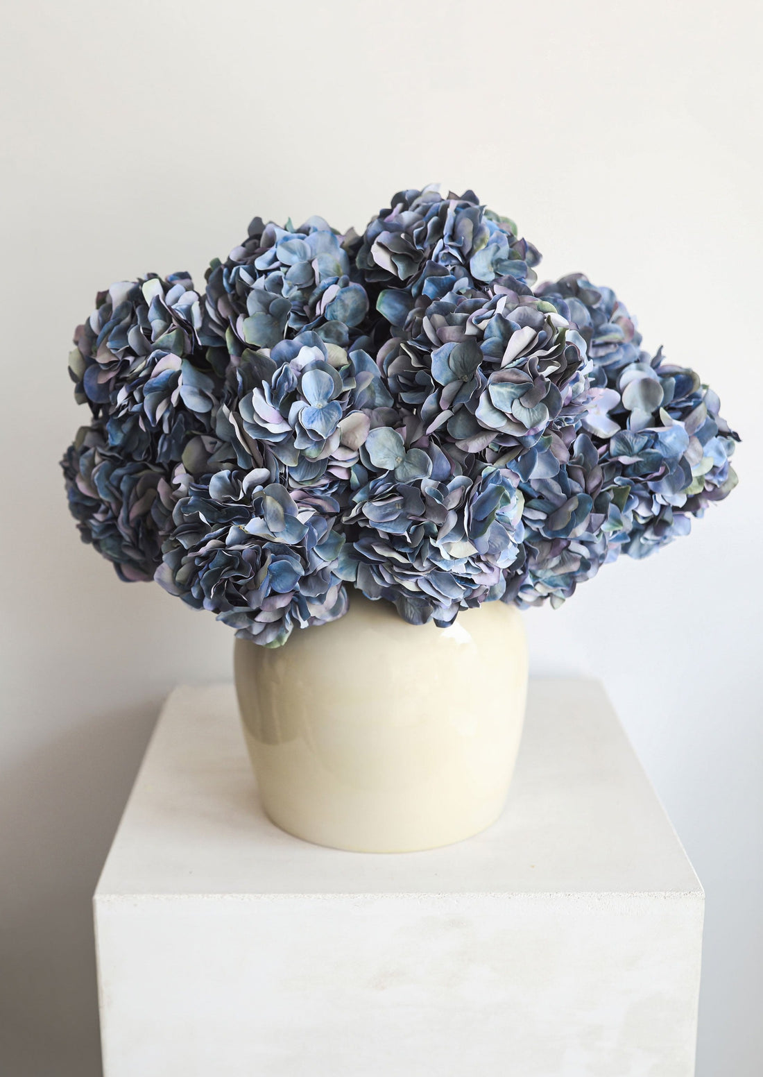 Artificial Blue Hydrangeas Arranged in the Afloral Glossy Cream Table Vase