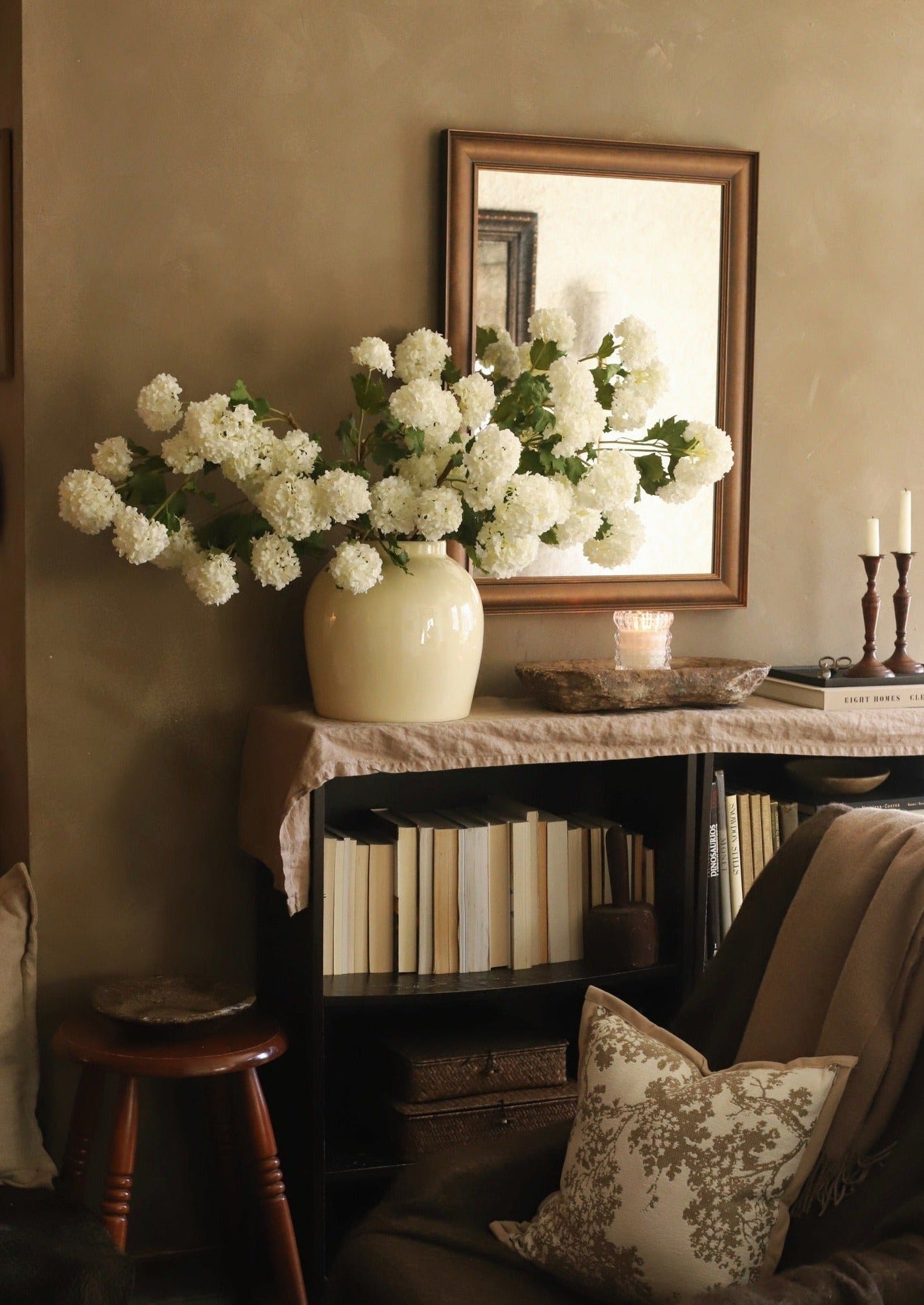 artificial white spring snowball flowers in glossy cream vase